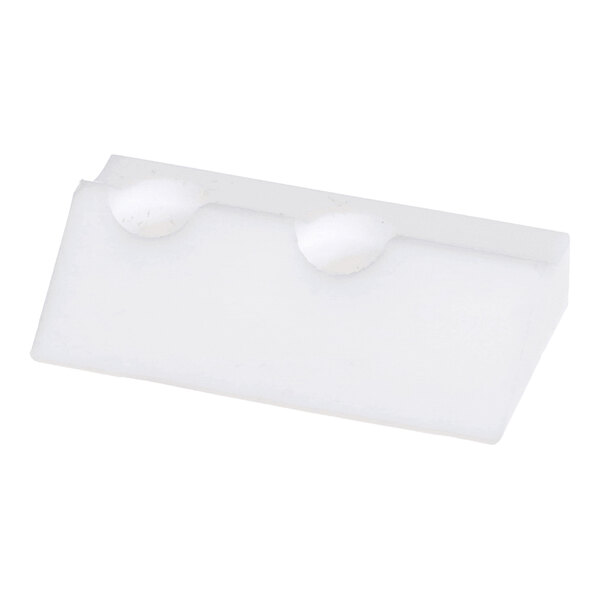 A white, rectangular plastic or rubber block with two rounded indentations on one edge.