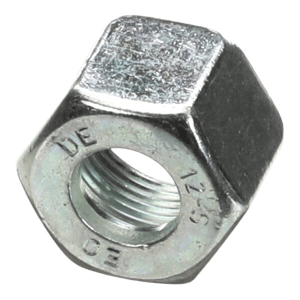 A close-up view of a metallic hexagonal nut with internal threading and some engraved markings on its surface.