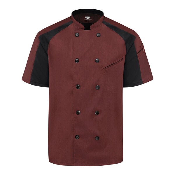 A short-sleeve chef coat with a double-breasted front, featuring a merlot body and black raglan sleeves, along with black buttons and a small chest pocket.