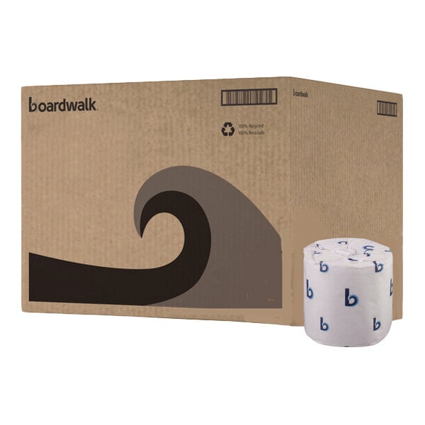 A large cardboard box with a wave design and the word 'boardwalk' printed on it, next to a single individually wrapped toilet paper roll.