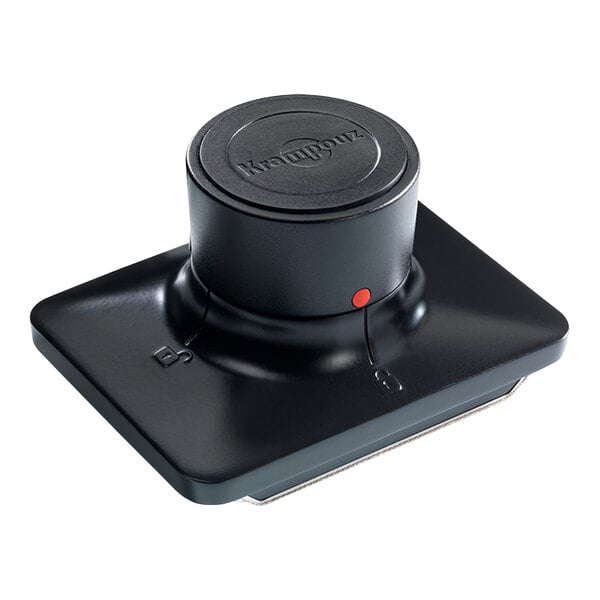A black, rectangular cleaning pad holder with a round handle and a visible red dot on the side.