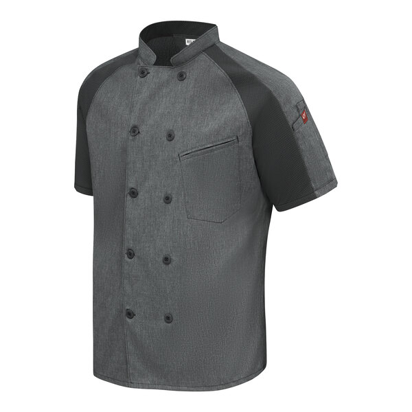 A short-sleeve, double-breasted, charcoal gray chef coat with black raglan sleeves and a chest pocket.