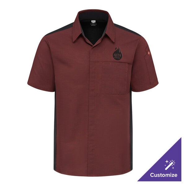 A short-sleeve, button-up shirt in a maroon color with black side panels, a chest pocket, and a small logo on the upper left chest.
