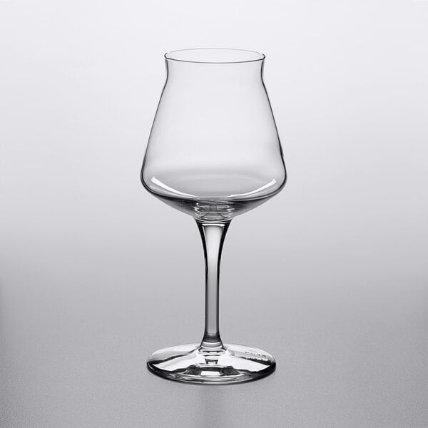 A clear, stemmed glass with a wide bowl and narrow rim, standing on a flat base.
