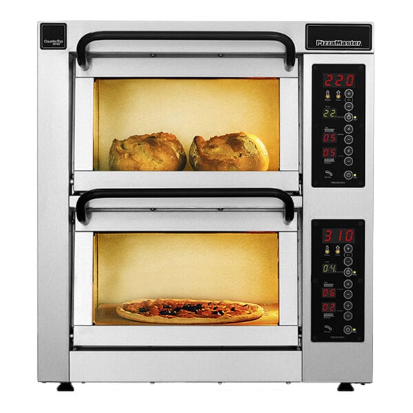 A stainless steel double-deck countertop oven with digital controls, showing two baked goods in the top chamber and a pizza in the bottom chamber.