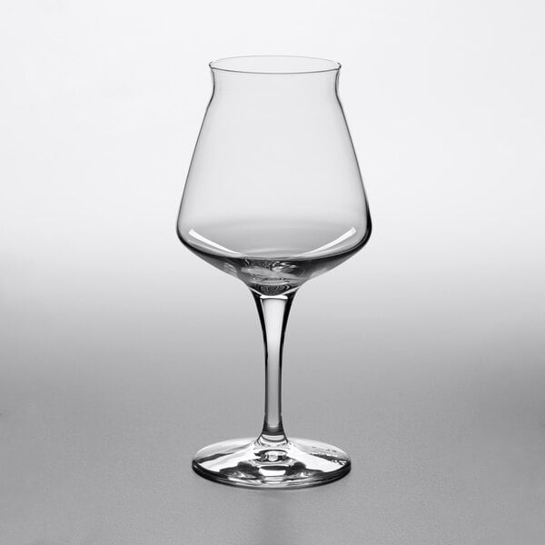 A clear, stemmed glass with a wide bowl and slightly flared rim, photographed against a plain background.