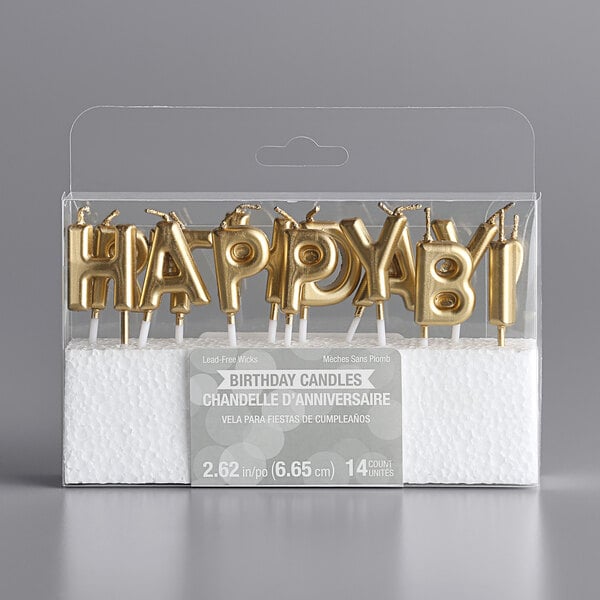 A set of gold letter-shaped birthday candles spelling out 'HAPPY BIRTHDAY!' arranged in a clear plastic package.