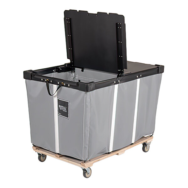 A large gray vinyl basket truck with a partially open black lid, mounted on a wooden base with four caster wheels.
