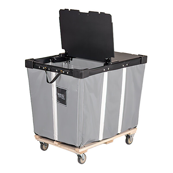 A large gray vinyl basket truck with a black hinged lid, mounted on a wooden base with four caster wheels.