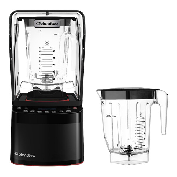 A black blender with a transparent sound enclosure and control panel, shown alongside an additional clear blending jar with a handle and measurement markings.