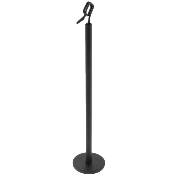 A tall, black, metal stand with a round base and a clip at the top, likely used for holding cards or menus.
