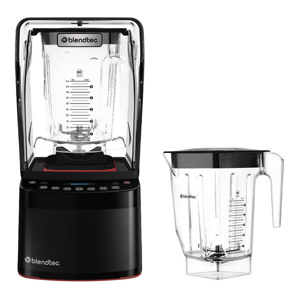 A black blender with a transparent sound enclosure and control panel, shown alongside an additional clear blending jar with a handle and measurement markings.