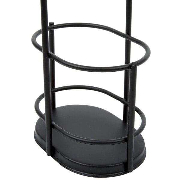 A black metal rack with an oval base and three circular rails, designed to hold bottles or containers upright.