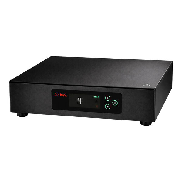 A black rectangular electronic device with a digital display, control buttons, and four short legs.