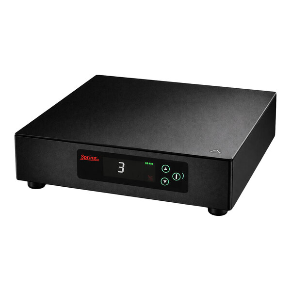 A black rectangular electronic device with a digital display, control buttons, and four small feet.