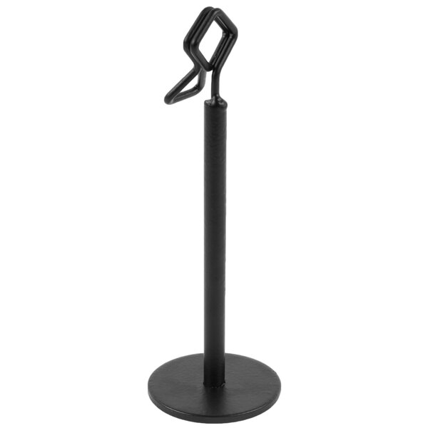 A black metal stand with a round base and a geometric clip at the top, designed to hold cards or menus upright.