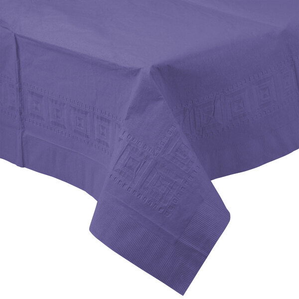 A purple Creative Converting tissue/poly table cover on a table.