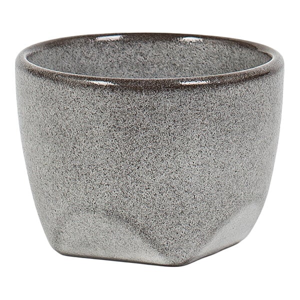 A small, gray, textured cup with a rounded rim and slightly tapered sides.