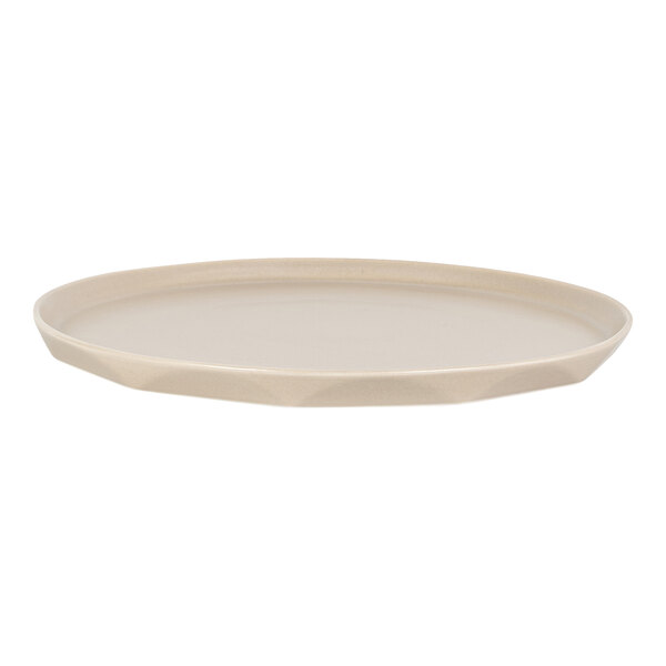 A round, shallow, beige-colored platter with a slightly raised edge and a smooth surface.