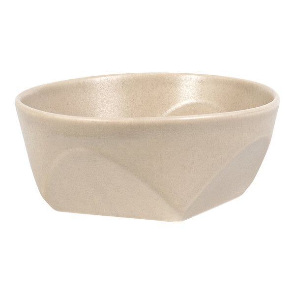 A beige, round bowl with a slightly angular exterior design and a smooth, glossy interior.