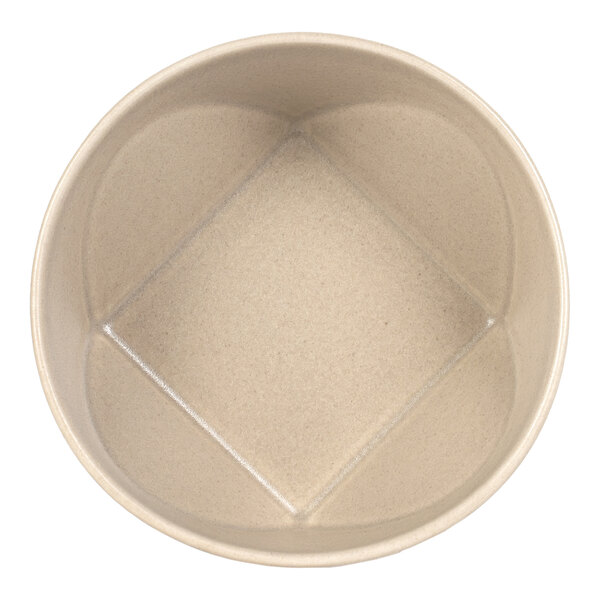 A round, cream-colored bowl with a unique square-shaped indentation in the center.