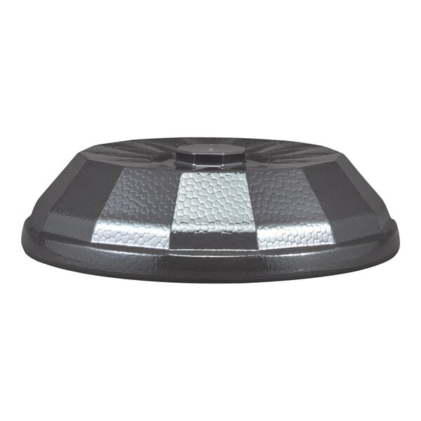 A low-profile, round, textured dome cover with alternating dark and metallic panels.