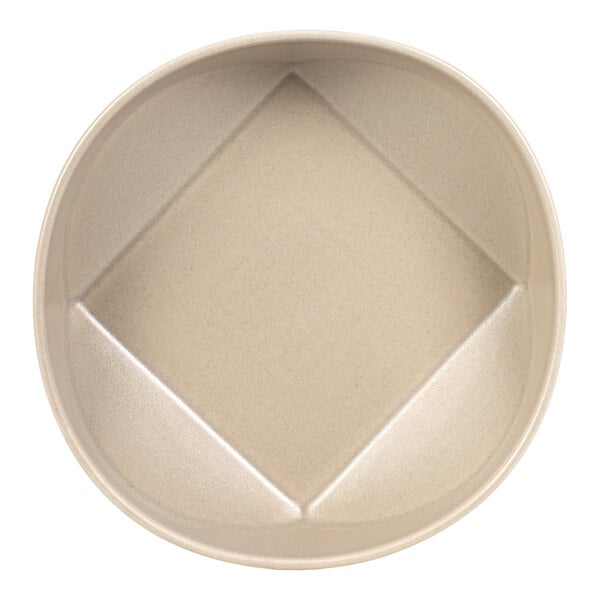 A round, cream-colored bowl with a unique square-shaped indentation in the center.