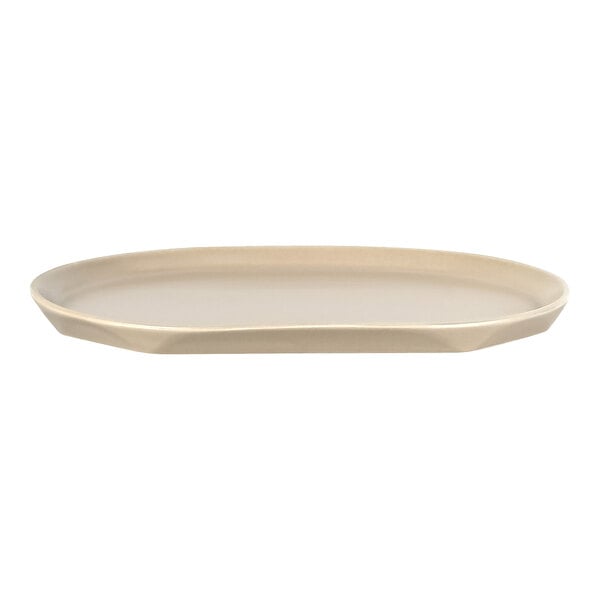 A beige, oval-shaped porcelain platter with slightly raised edges and a smooth surface.