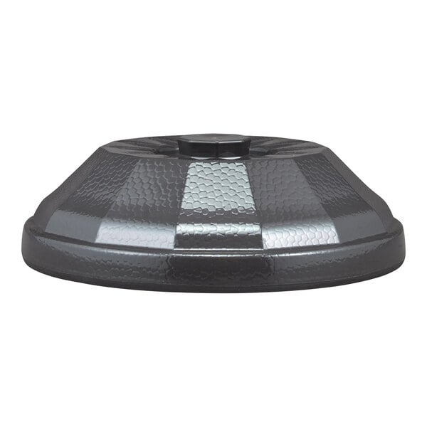A dark, textured, dome-shaped plastic cover with a central knob, viewed from the side.