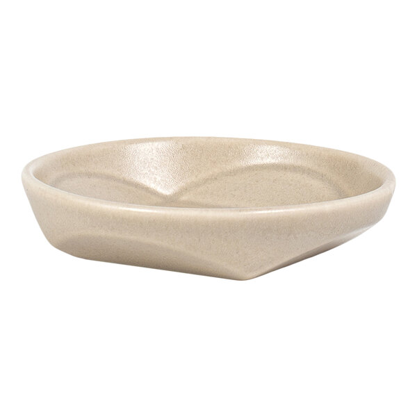 A small, round, beige dish with a smooth, slightly textured surface and gently sloped sides.