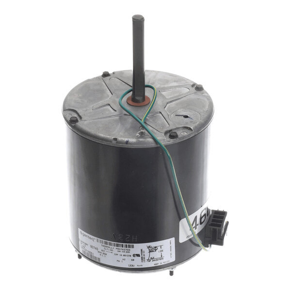 A cylindrical electric motor with a central shaft, attached wire, and a label with technical specifications.