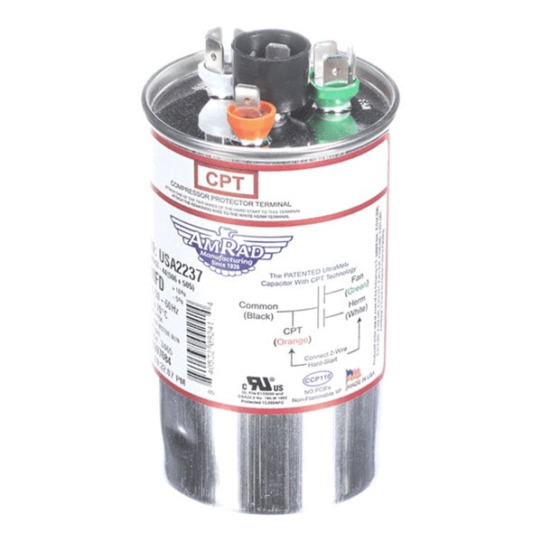 A cylindrical metallic capacitor with labeled terminals and a detailed product label on the side.