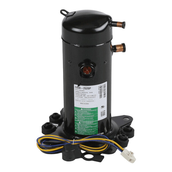 A black cylindrical mechanical component with two copper pipe fittings, a label, and attached wires, mounted on a base with four bolt holes.