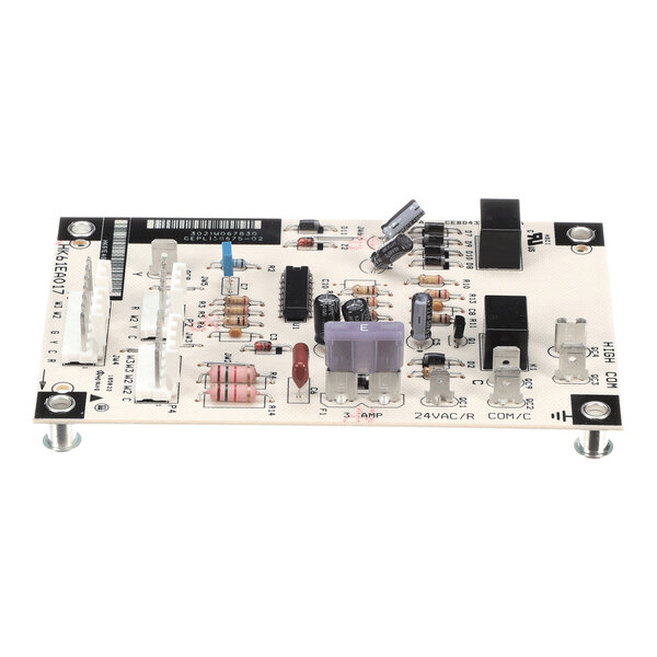 A rectangular electronic circuit board with various components such as resistors, capacitors, connectors, and a fuse mounted on it.