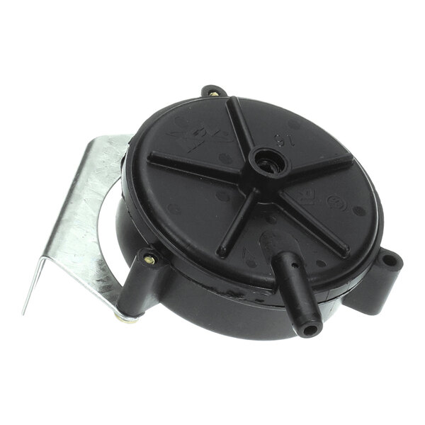 A round black plastic component with a protruding nozzle and a metal mounting bracket.