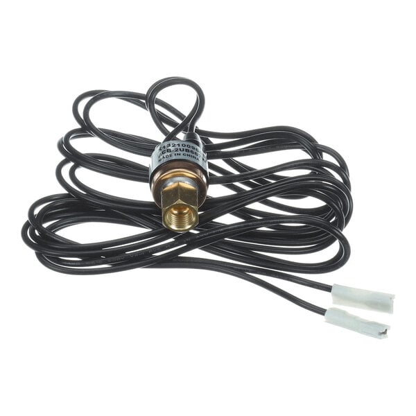 A small cylindrical metal component with attached black wires and white connectors, likely an electrical or mechanical sensor or switch.