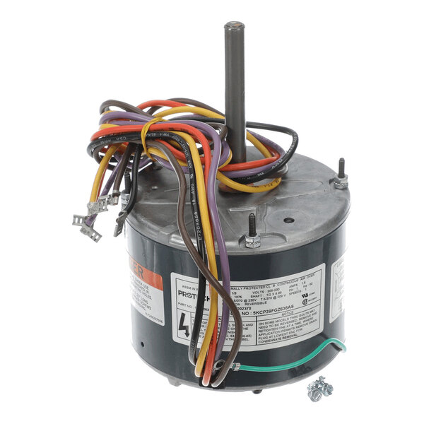 A cylindrical electric motor with a central shaft and multiple colored wires extending from the top.