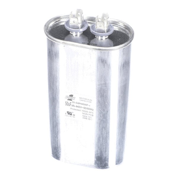 A metallic cylindrical component with two electrical terminals on top, likely an electrical capacitor.