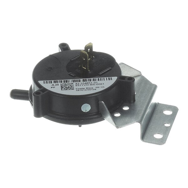 A round black component with two metal terminals, a protruding nozzle, a white label with text and barcode, and an attached metal mounting bracket.