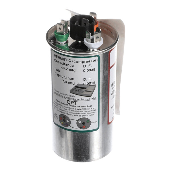 A cylindrical metallic capacitor with three electrical terminals on top and a label displaying capacitance and other specifications.