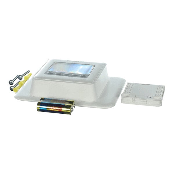 A white electronic device with a digital display, accompanied by screws, wall anchors, a battery, and a plastic mounting plate.