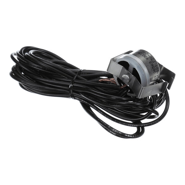 A coiled black wire attached to a small cylindrical sensor or component with printed markings.