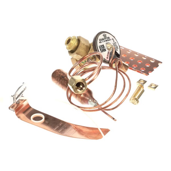A collection of metal components including copper tubing, brass fittings, a coiled wire, and mounting hardware, arranged on a white background.