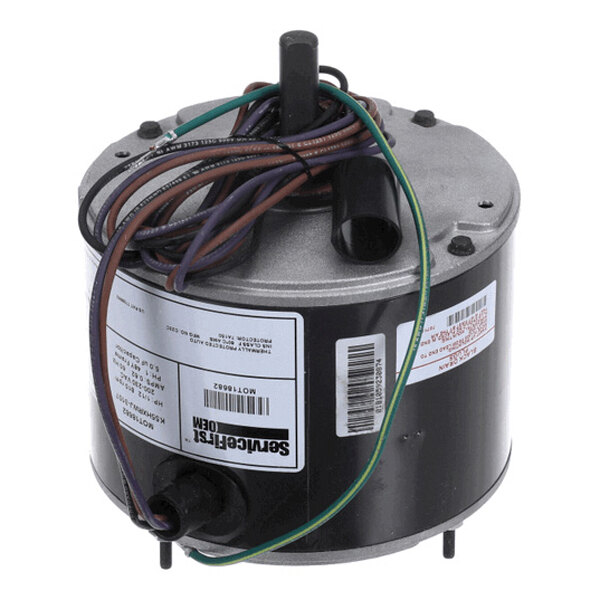 A cylindrical electric motor with attached wires and labels on its side.