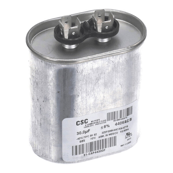 A metallic, oval-shaped electrical capacitor with two terminal connectors on top and a white label with specifications on the side.
