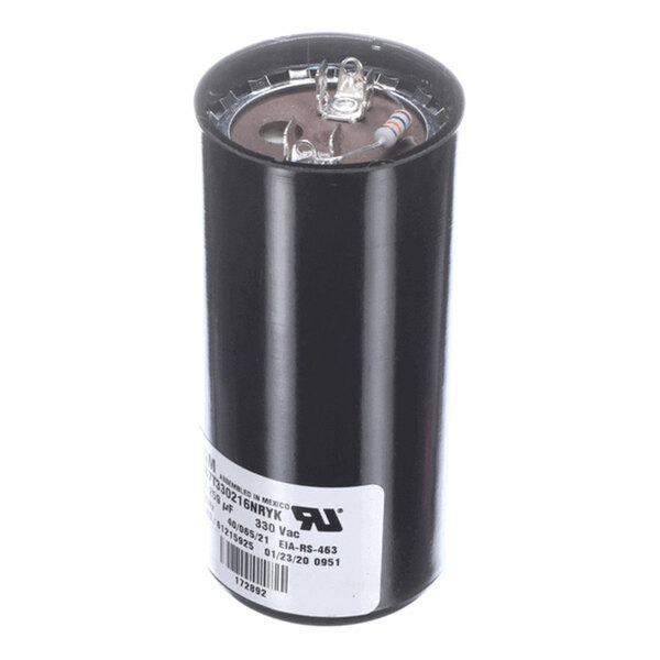 A cylindrical black capacitor with two terminals on top and a white label with text on the side.