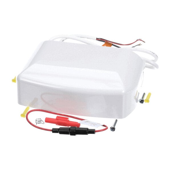 A white rectangular plastic component with attached wires, screws, and connectors visible around it.