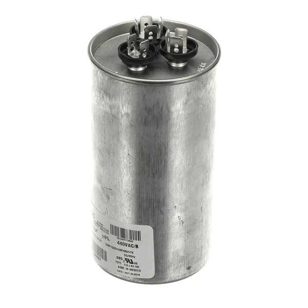 A cylindrical metal component with two sets of electrical terminals on top and a label on the side.