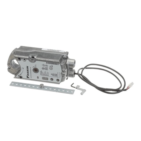A metallic actuator device with attached wiring, a mounting bracket, and a small tool, all placed on a white background.