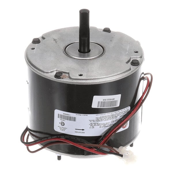 A cylindrical electric motor with a central shaft, attached wires, and identification labels on its side.
